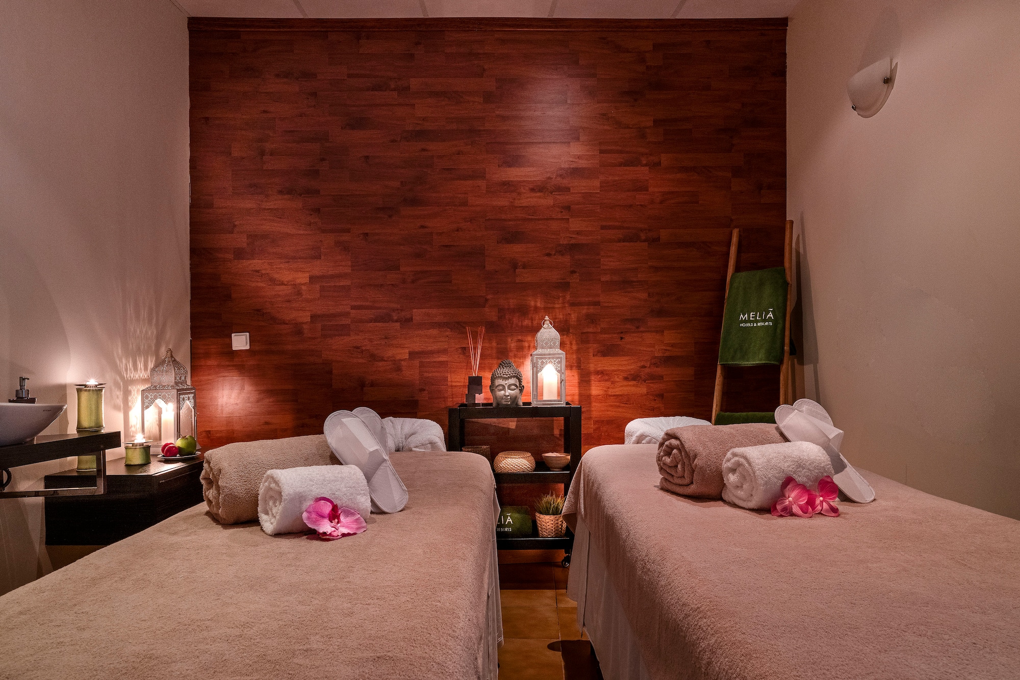 a room with two beds and candles