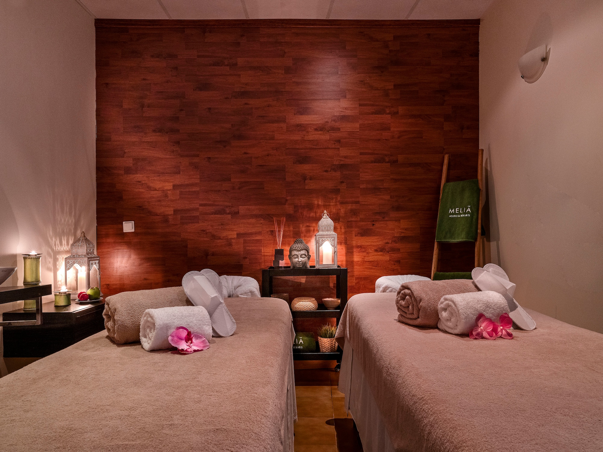 a room with two beds and candles