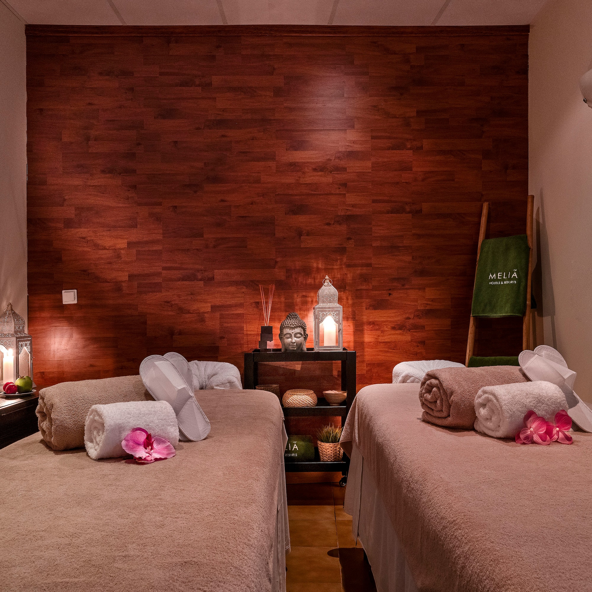 a room with two beds and candles