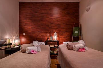 a room with two beds and candles