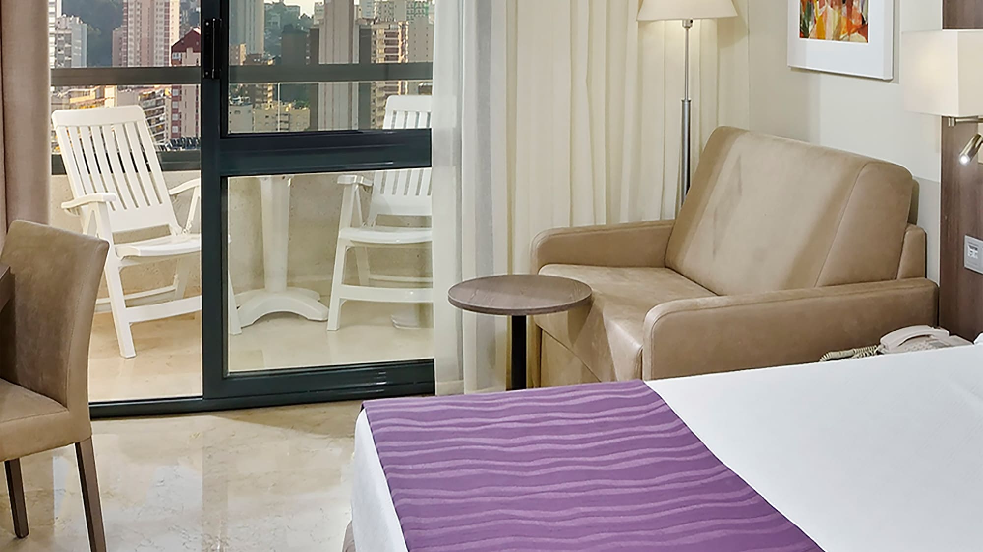 a room with a bed and a couch and a chair