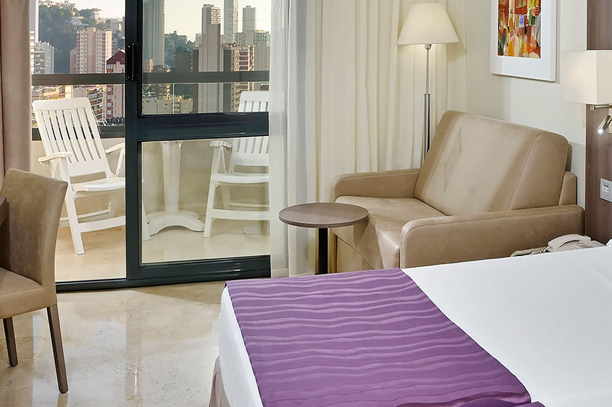 a room with a bed and a couch and a chair