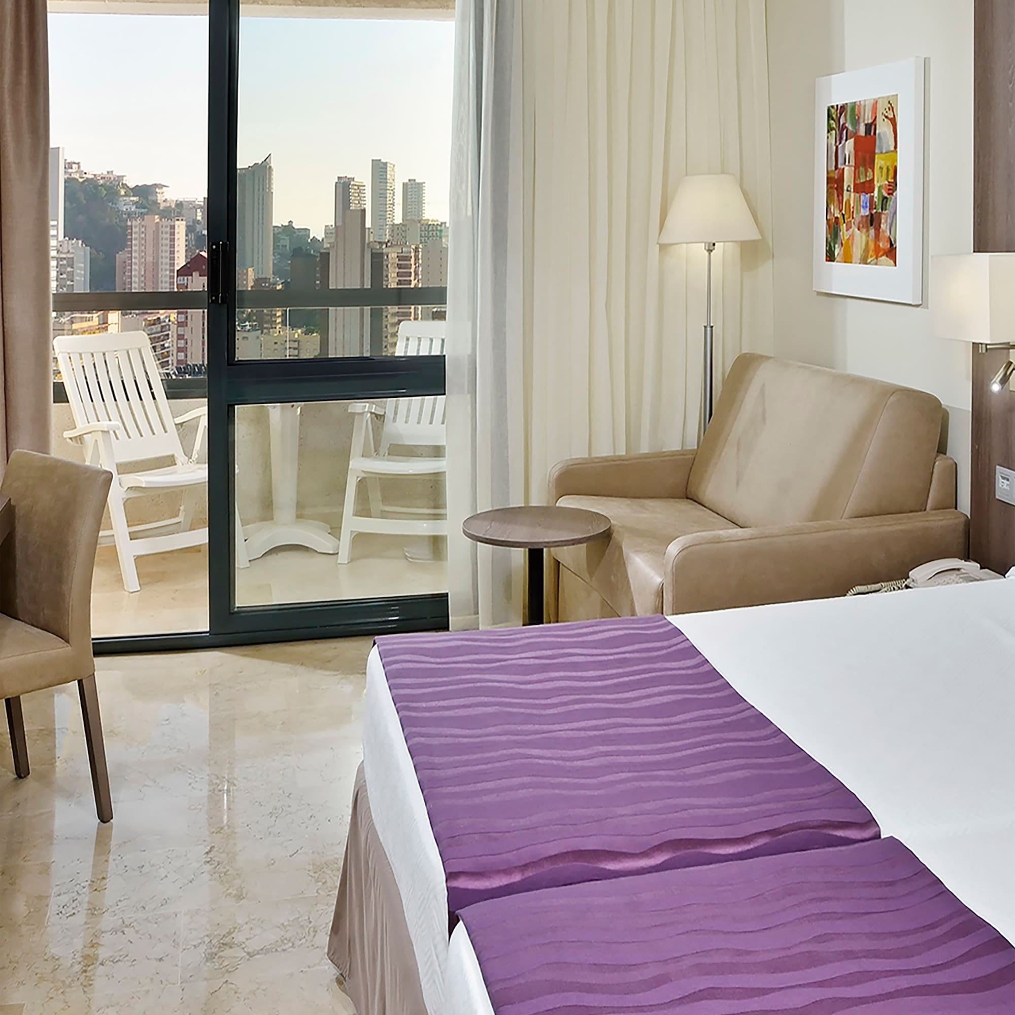 a room with a bed and a couch and a chair