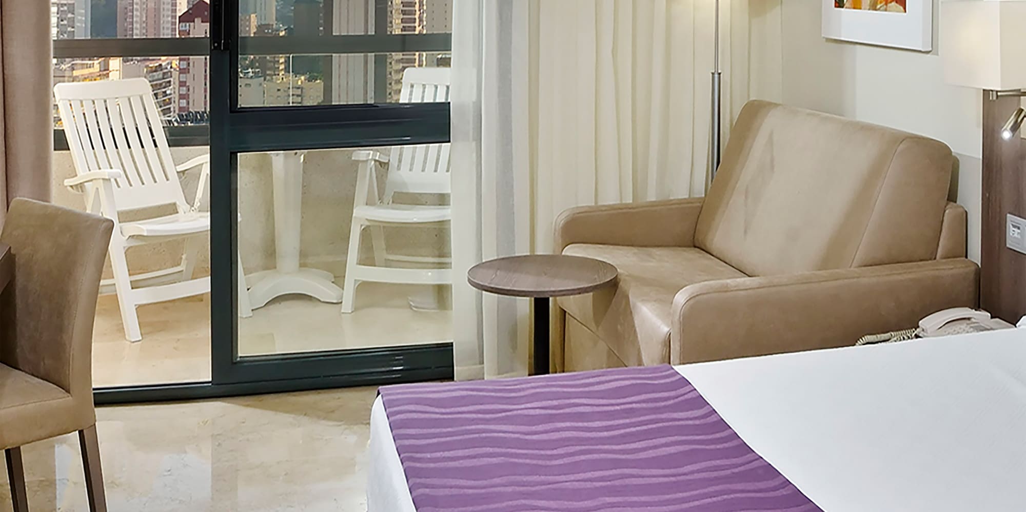 a room with a bed and a couch and a chair