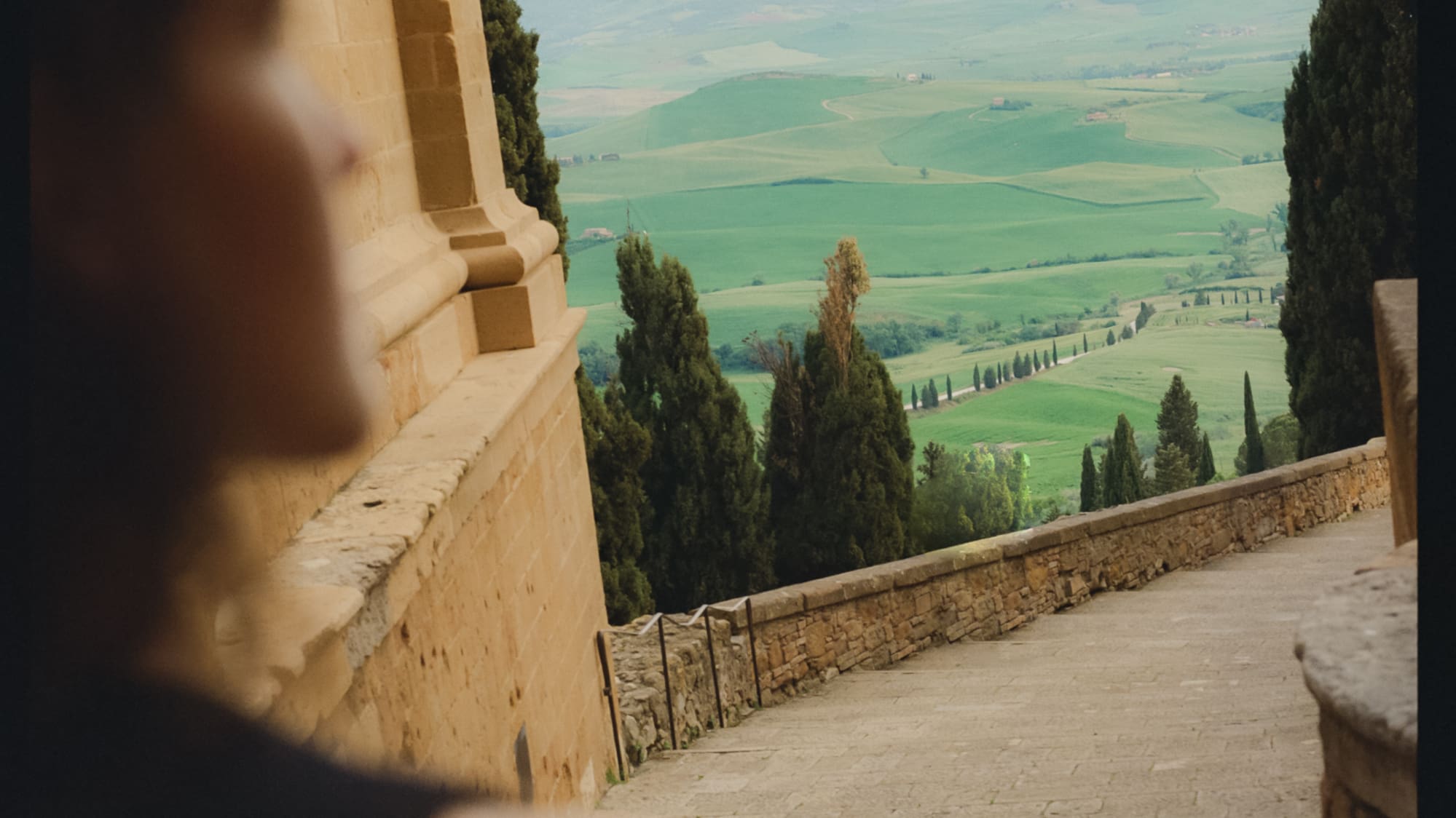 a person looking down a stone staircase