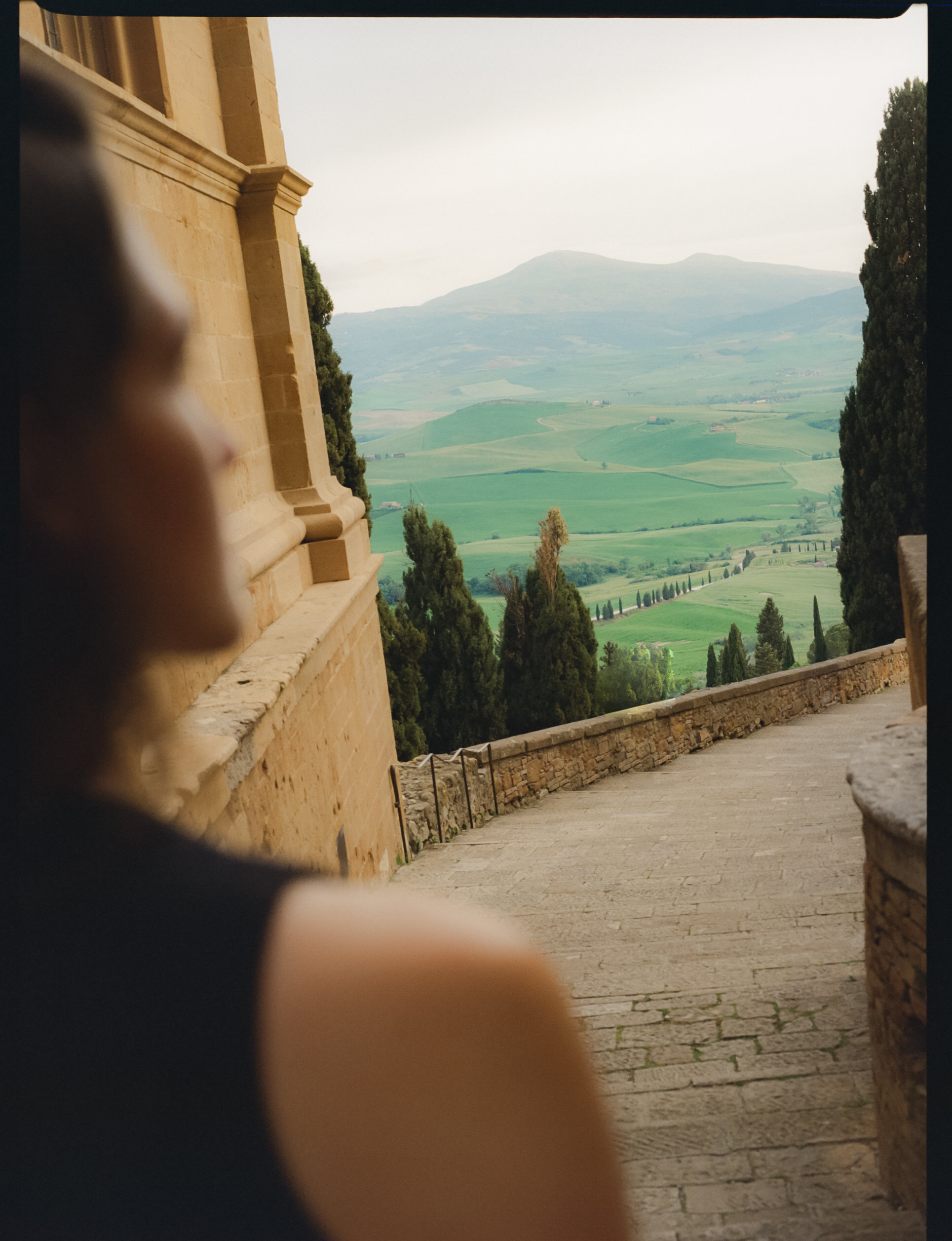 a person looking down a stone staircase