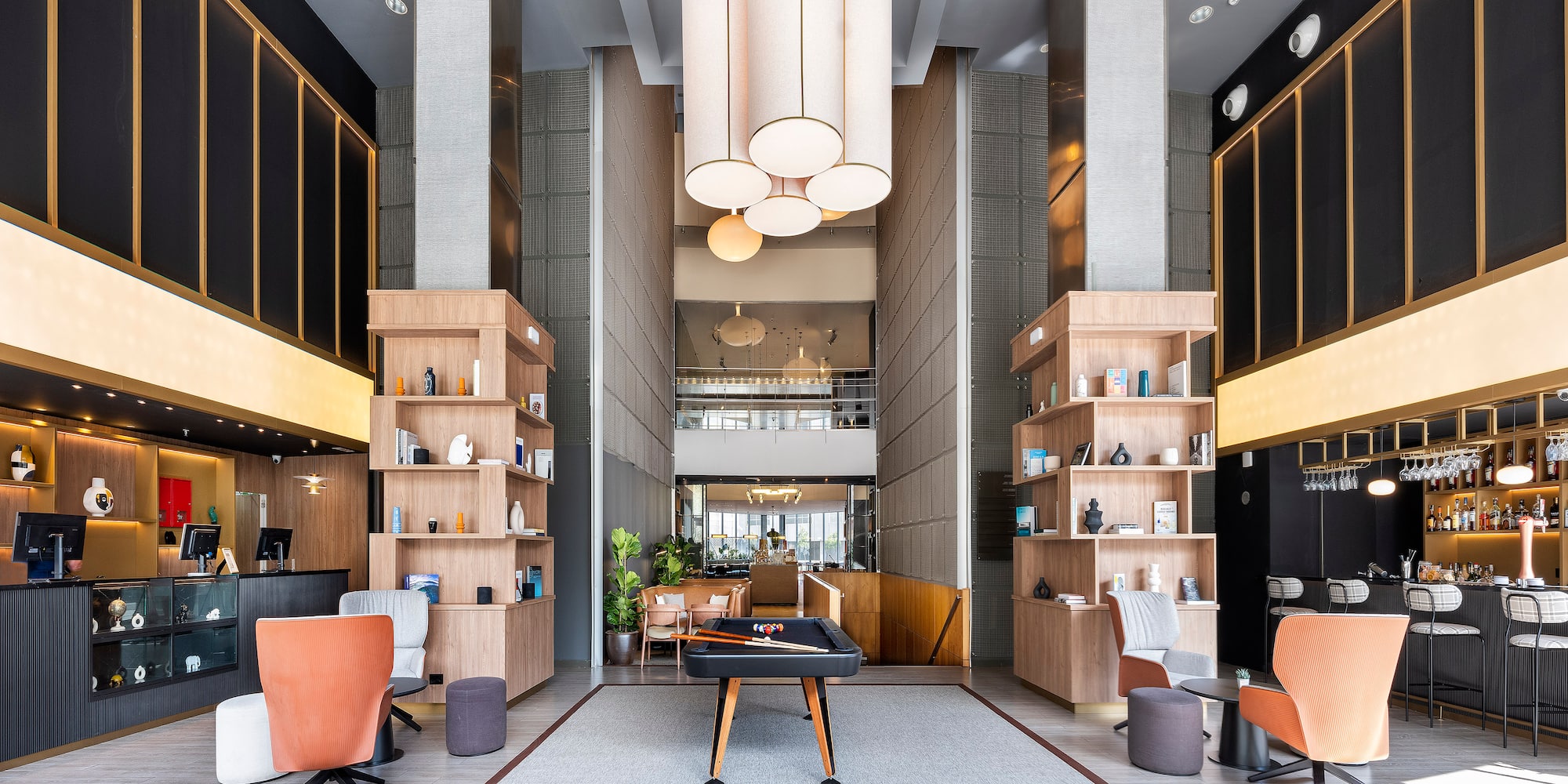 a room with a pool table and chairs