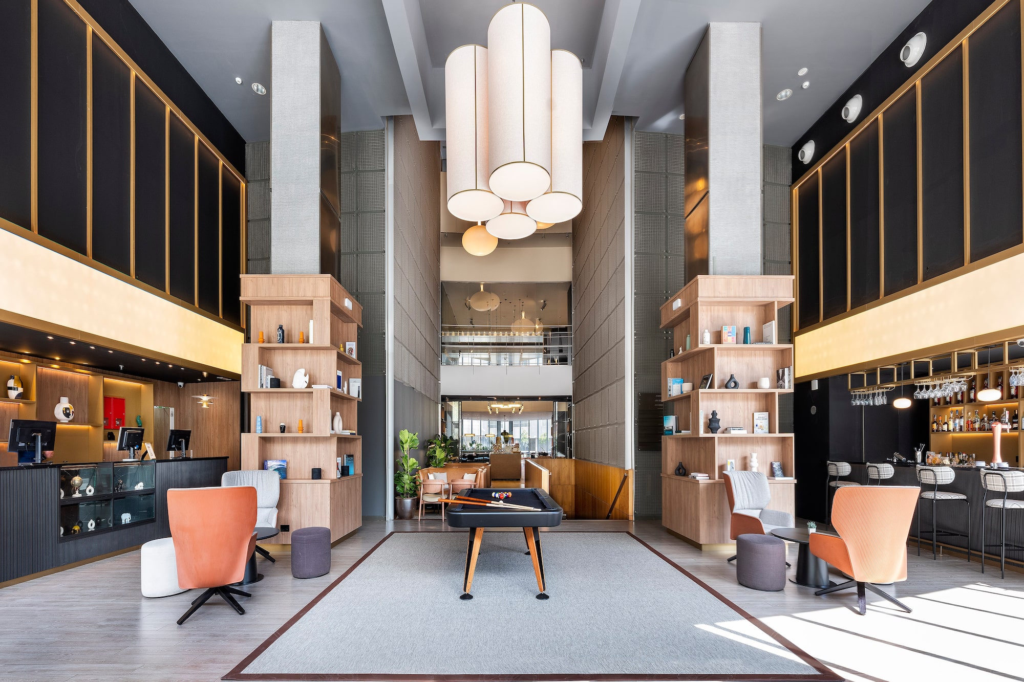 a room with a pool table and chairs