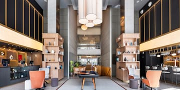 a room with a pool table and chairs