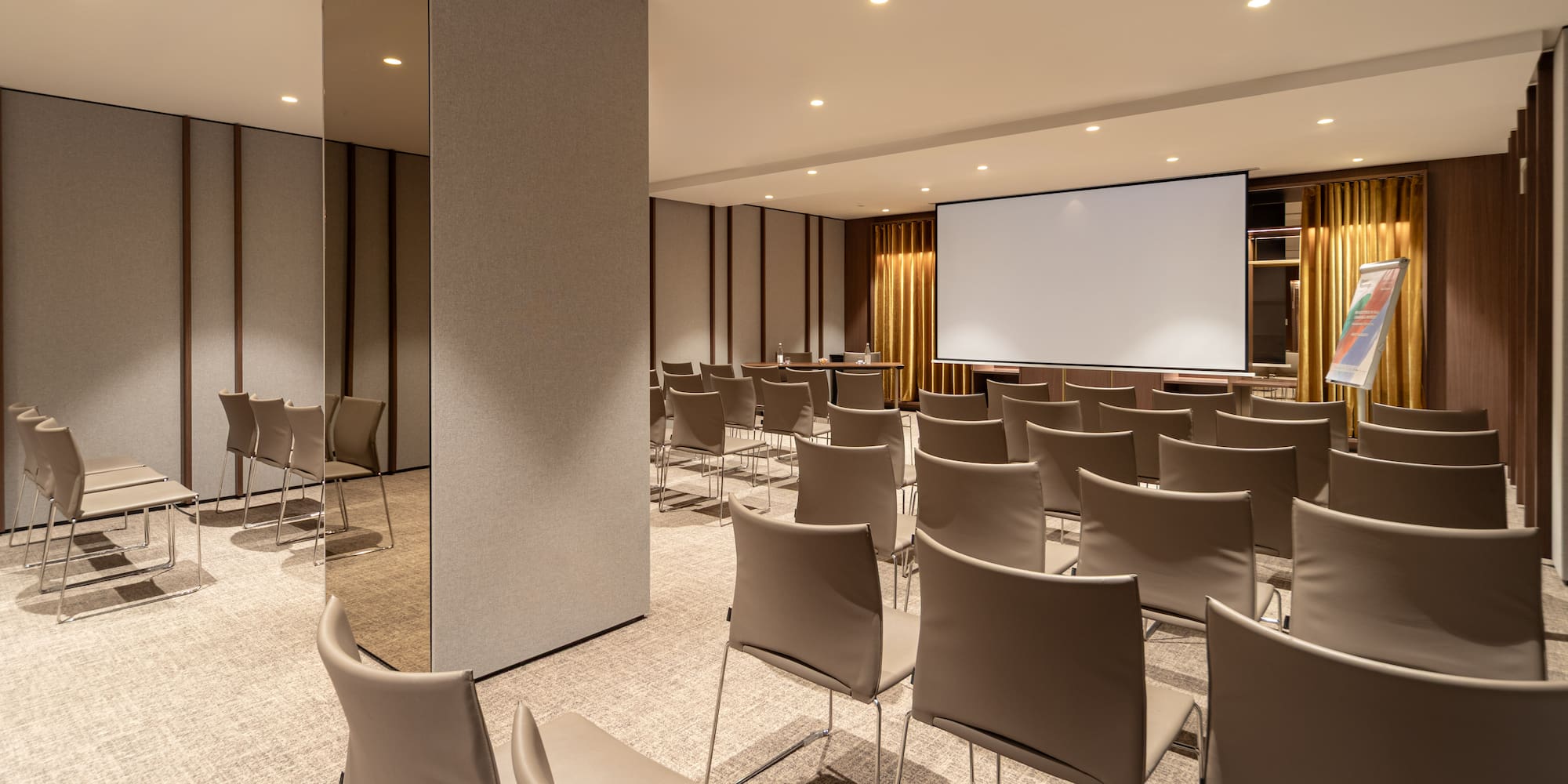 a room with chairs and a projector screen