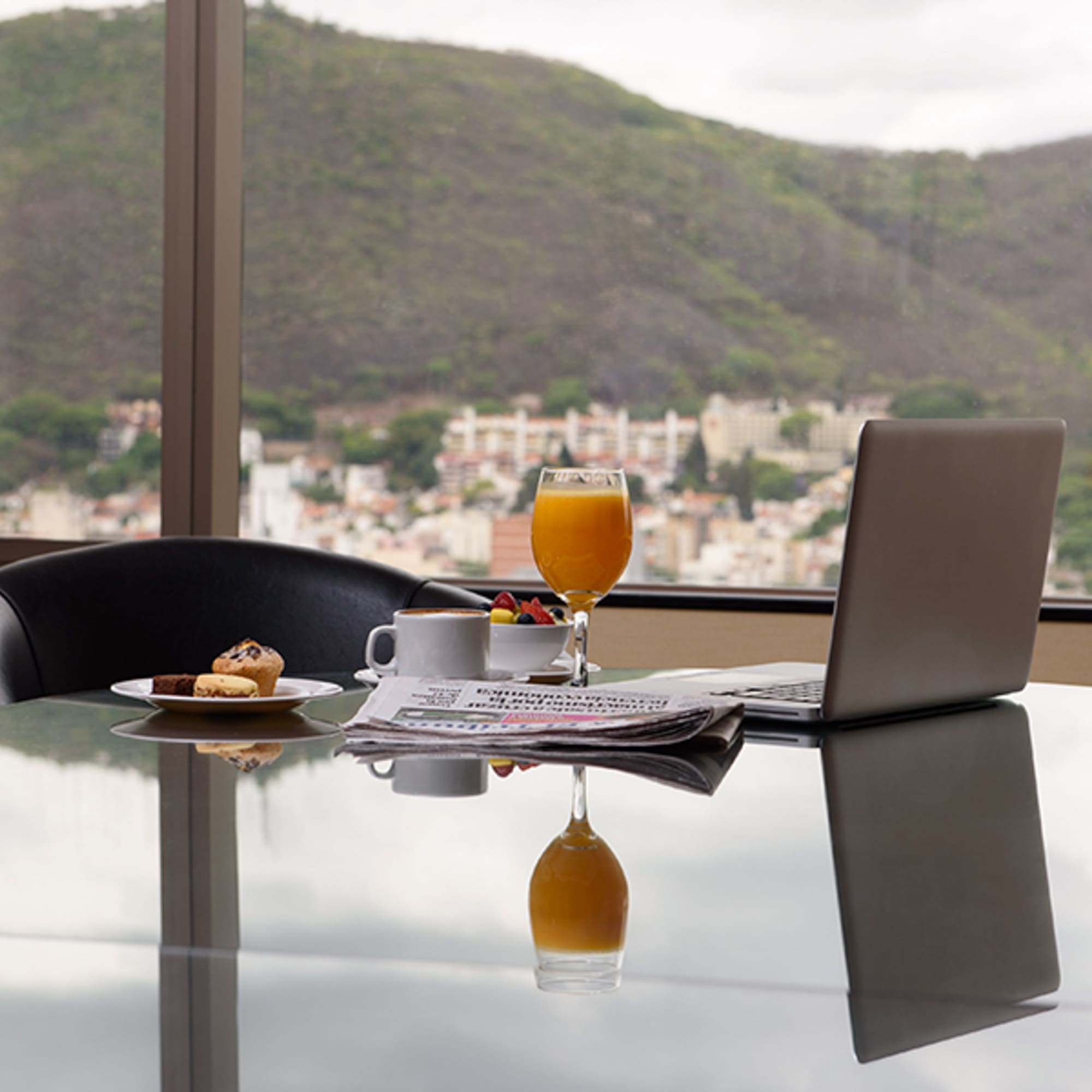 a laptop and a plate of food on a table