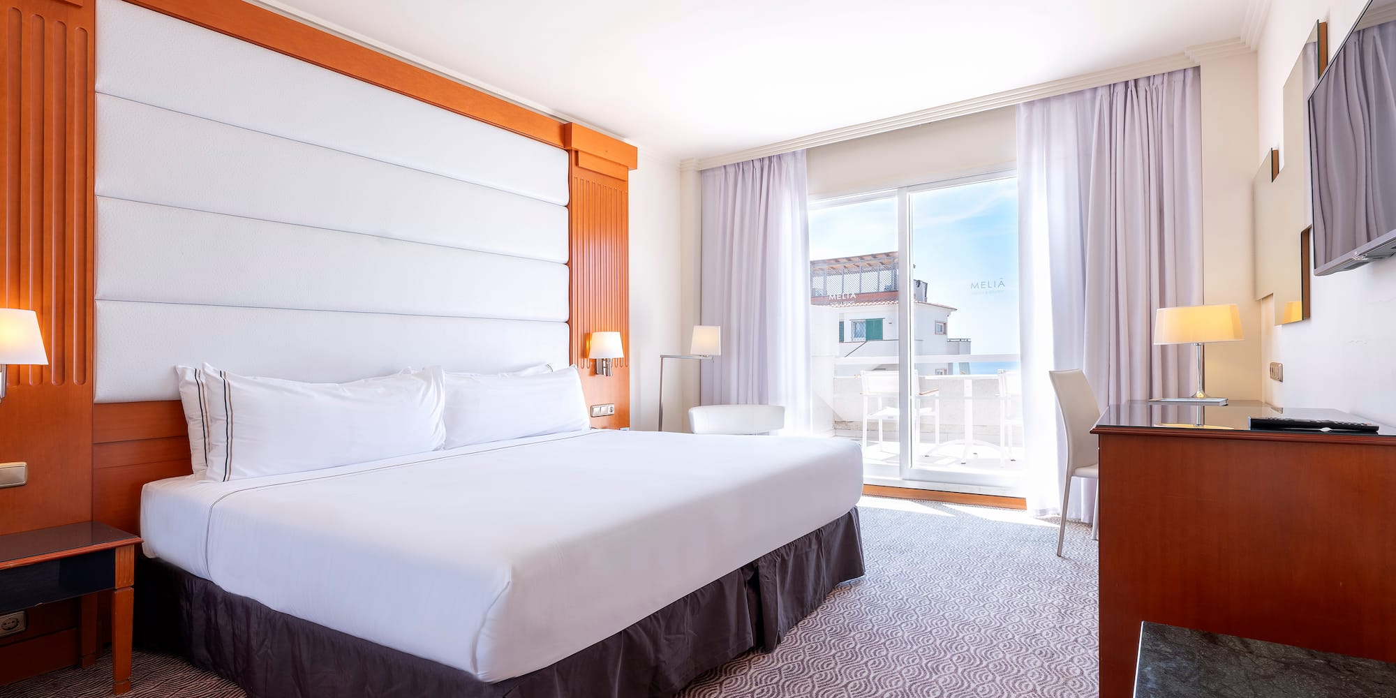 a room with a bed and a desk