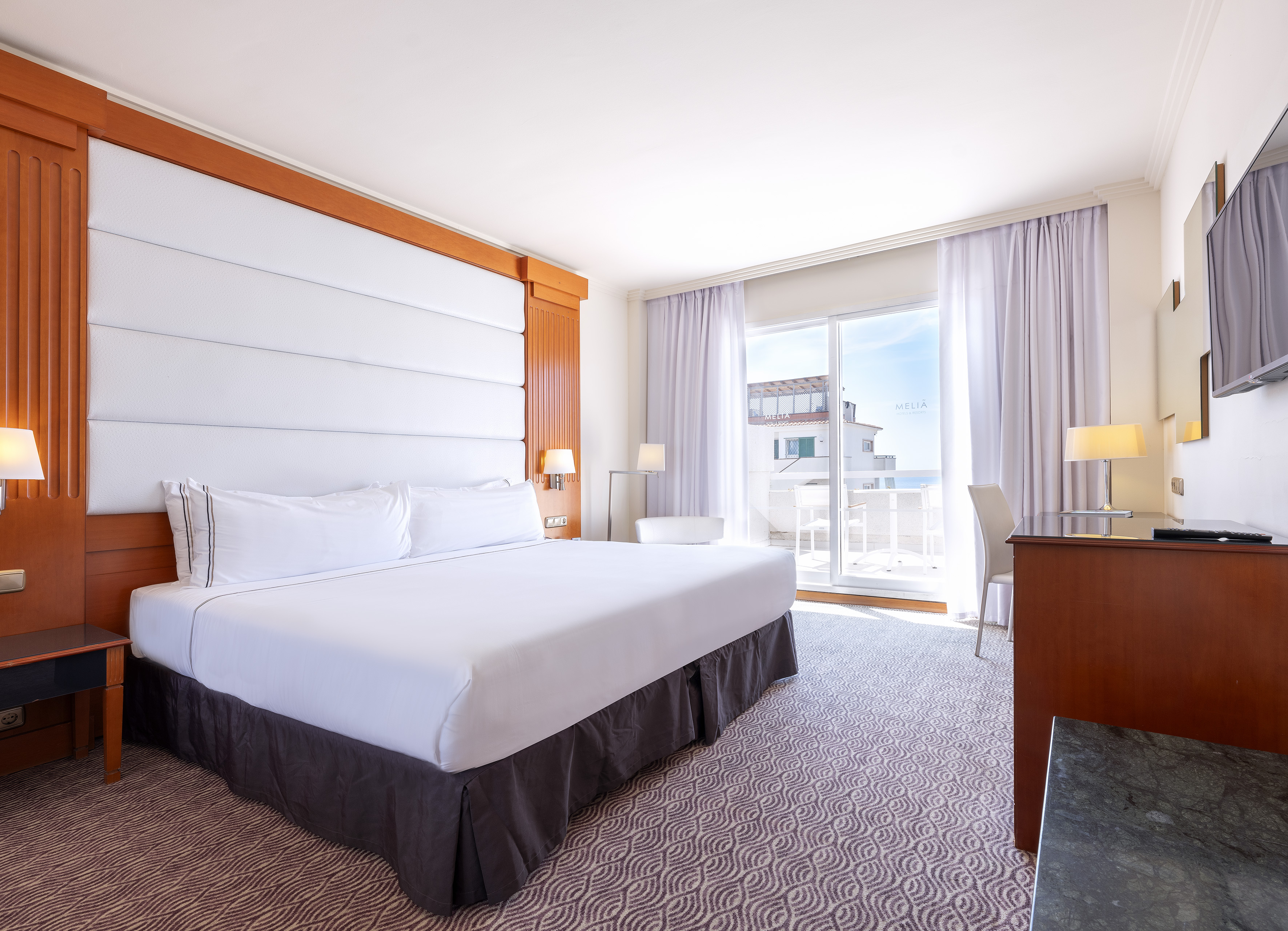 a room with a bed and a desk