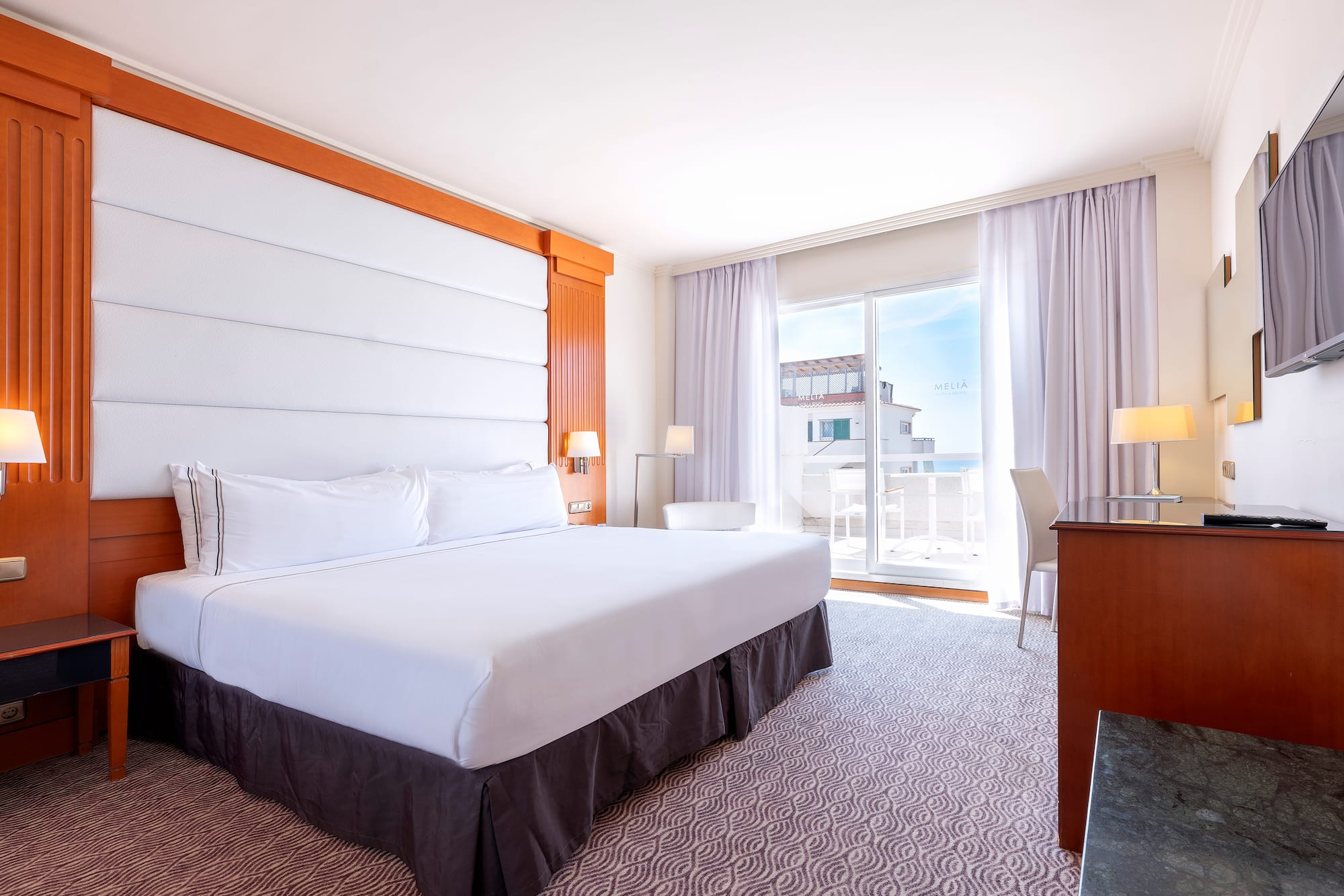 a room with a bed and a desk