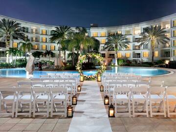 a wedding ceremony in front of a pool