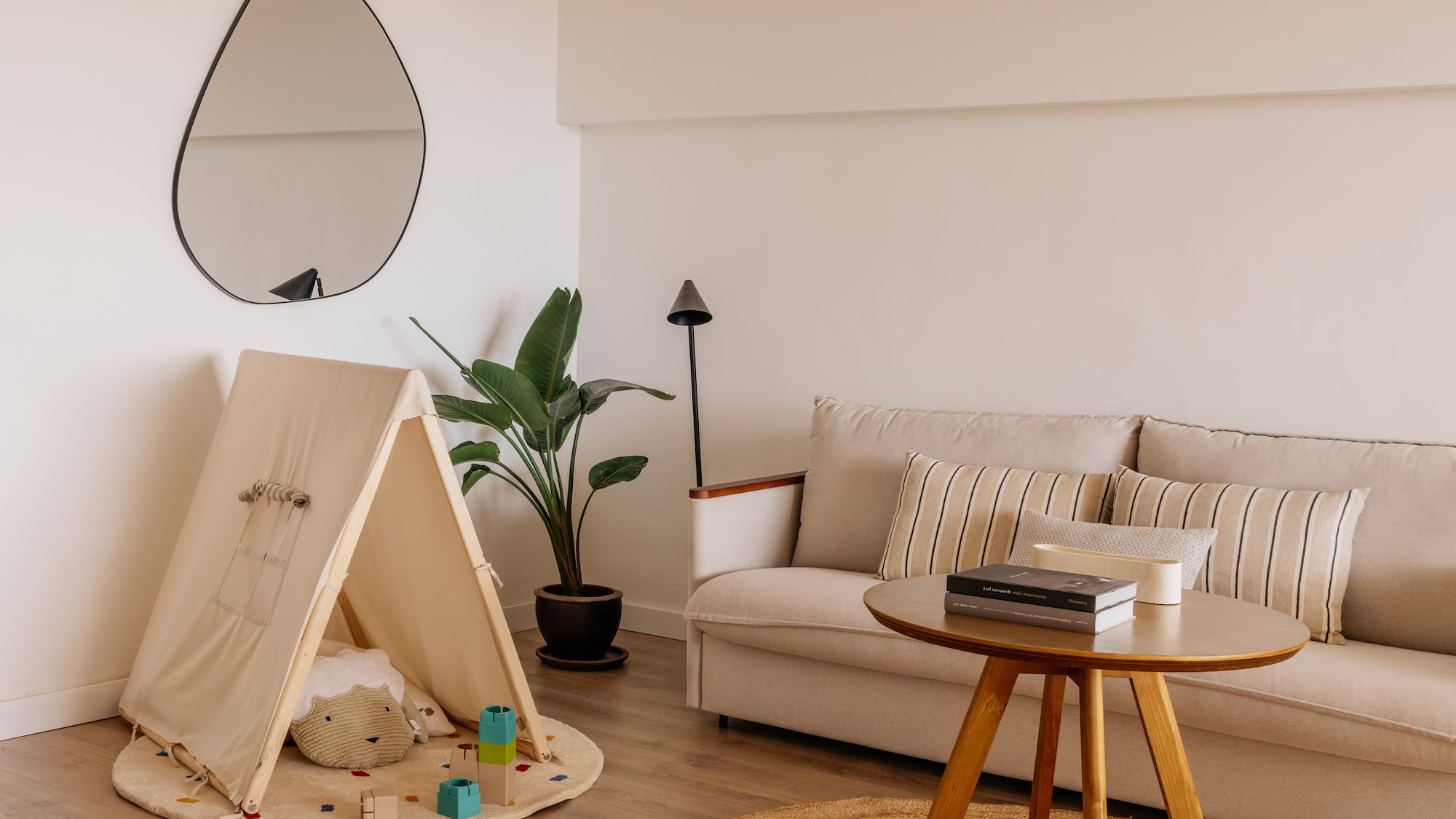 a room with a couch and a play tent