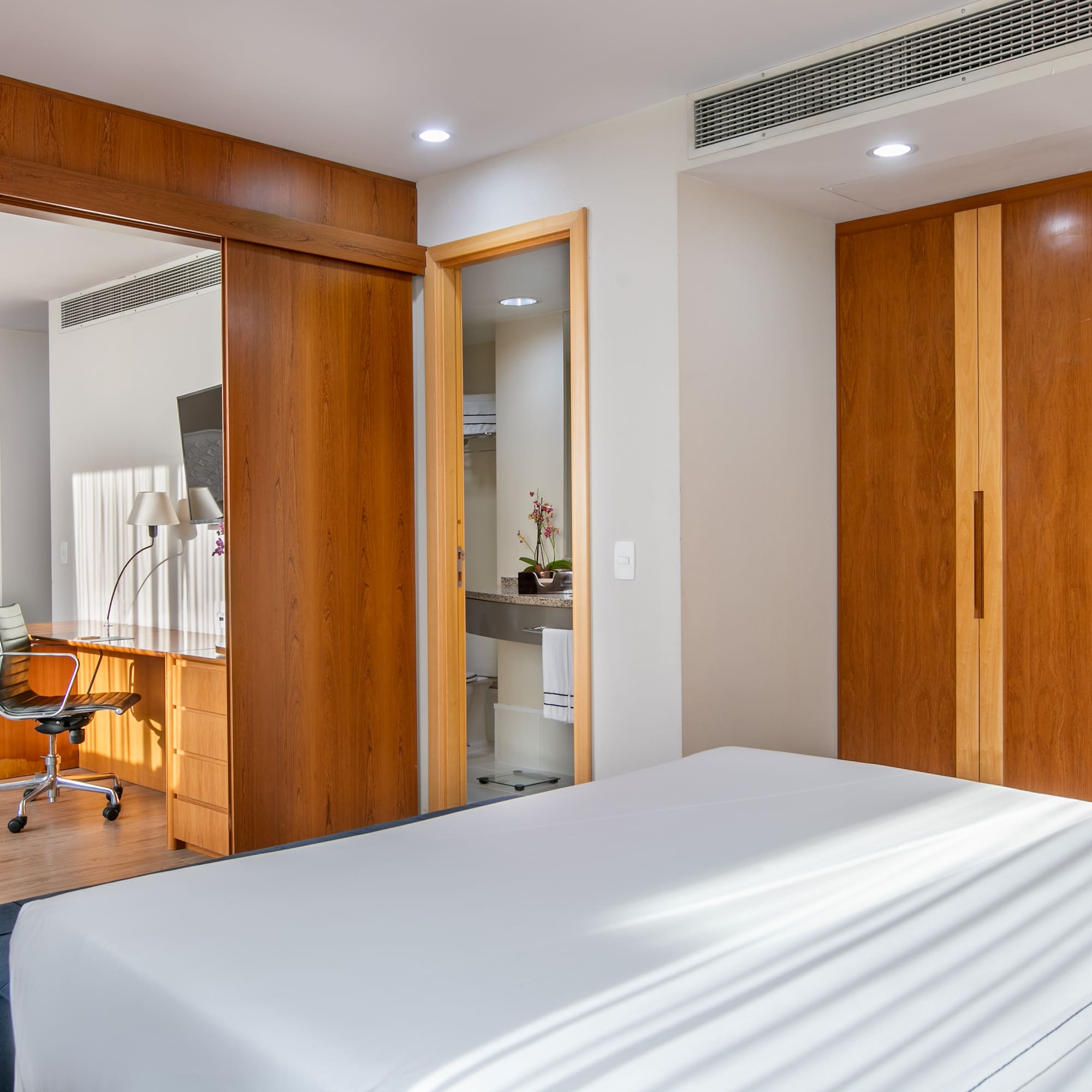 a bedroom with a bed and a desk