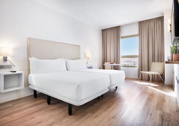 a room with two beds and a wood floor