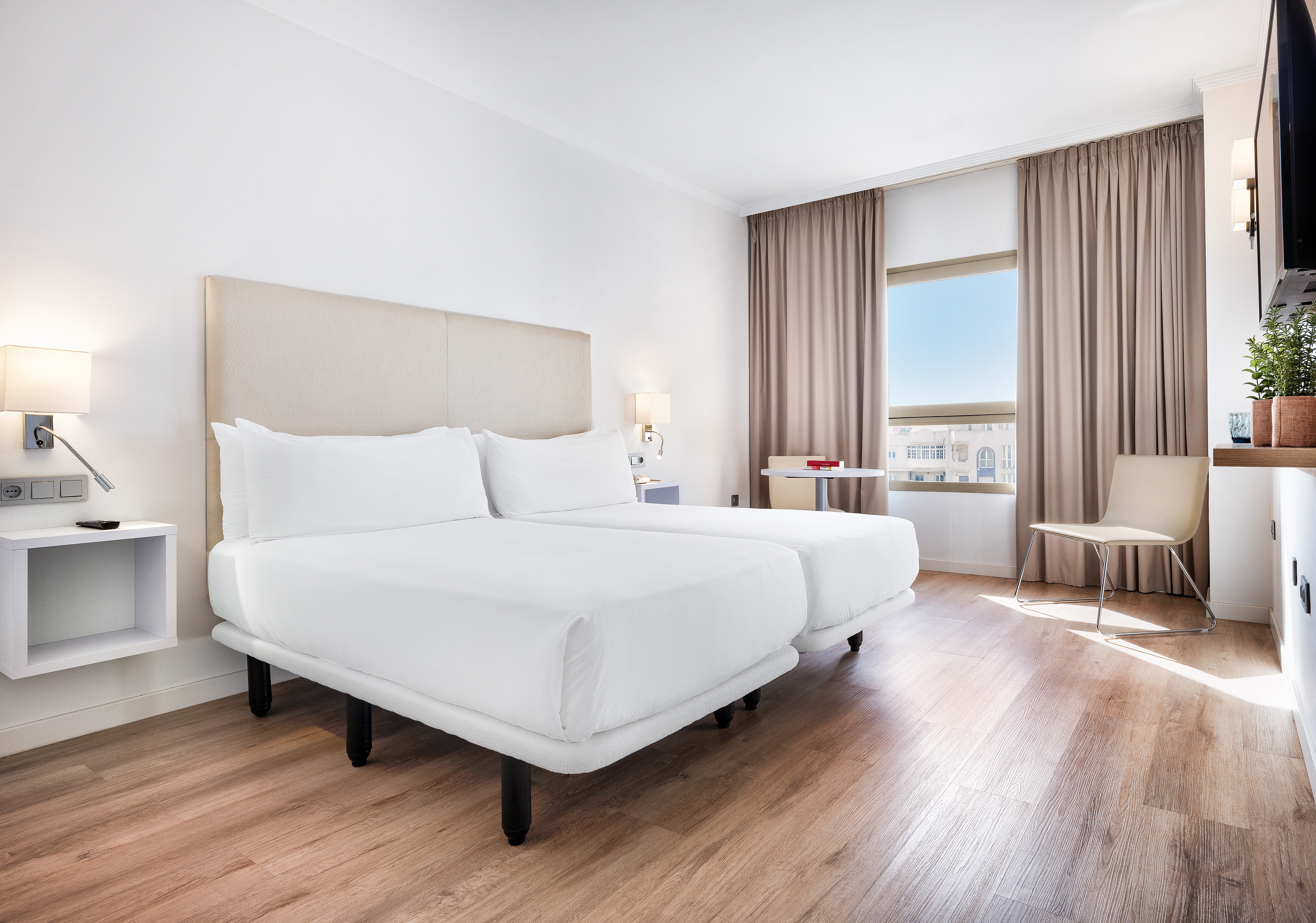 a room with two beds and a wood floor