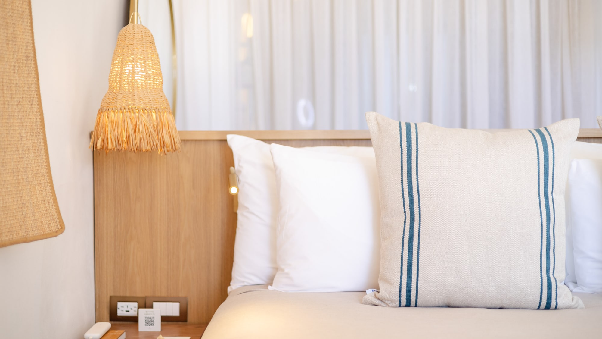 a bed with pillows and a lamp