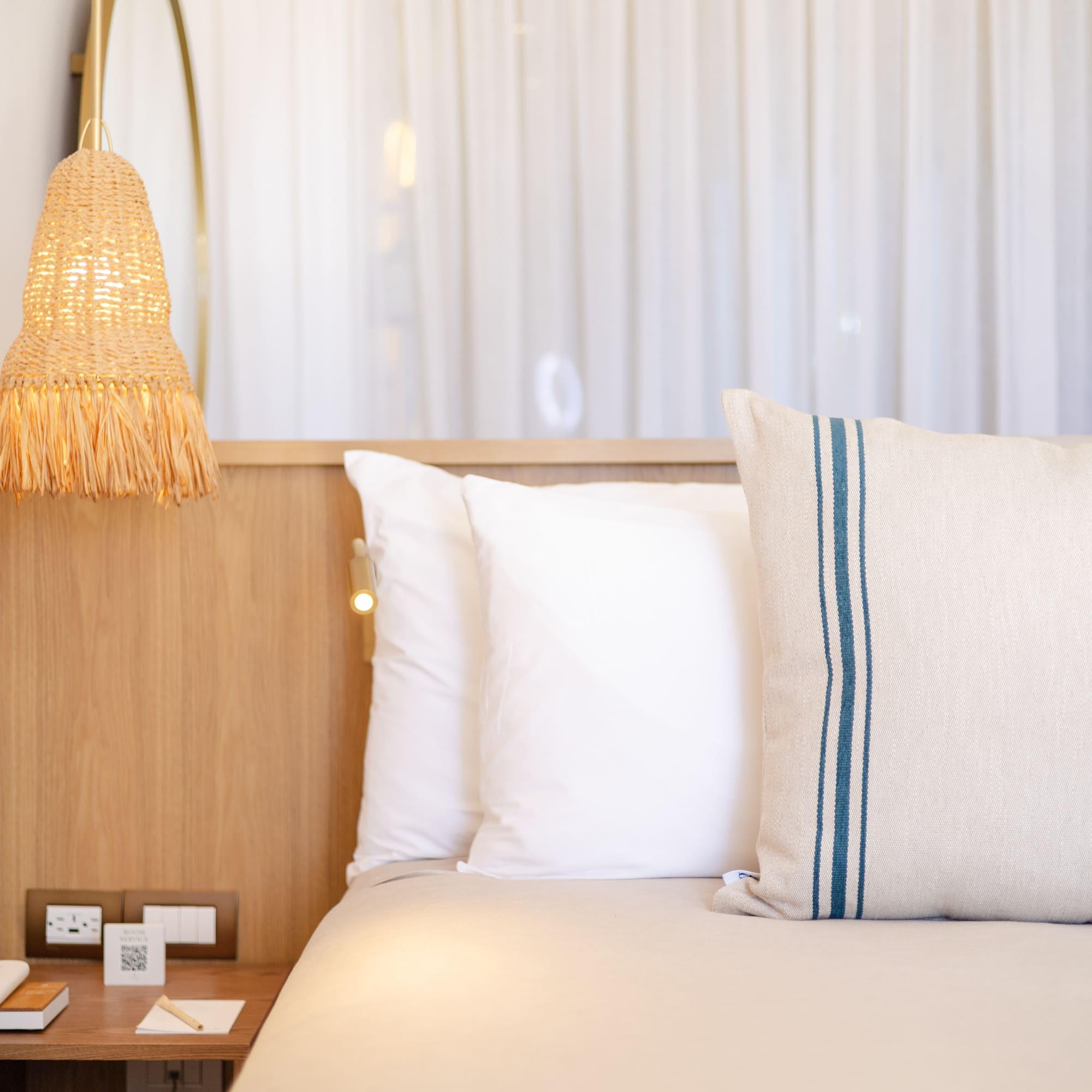 a bed with pillows and a lamp