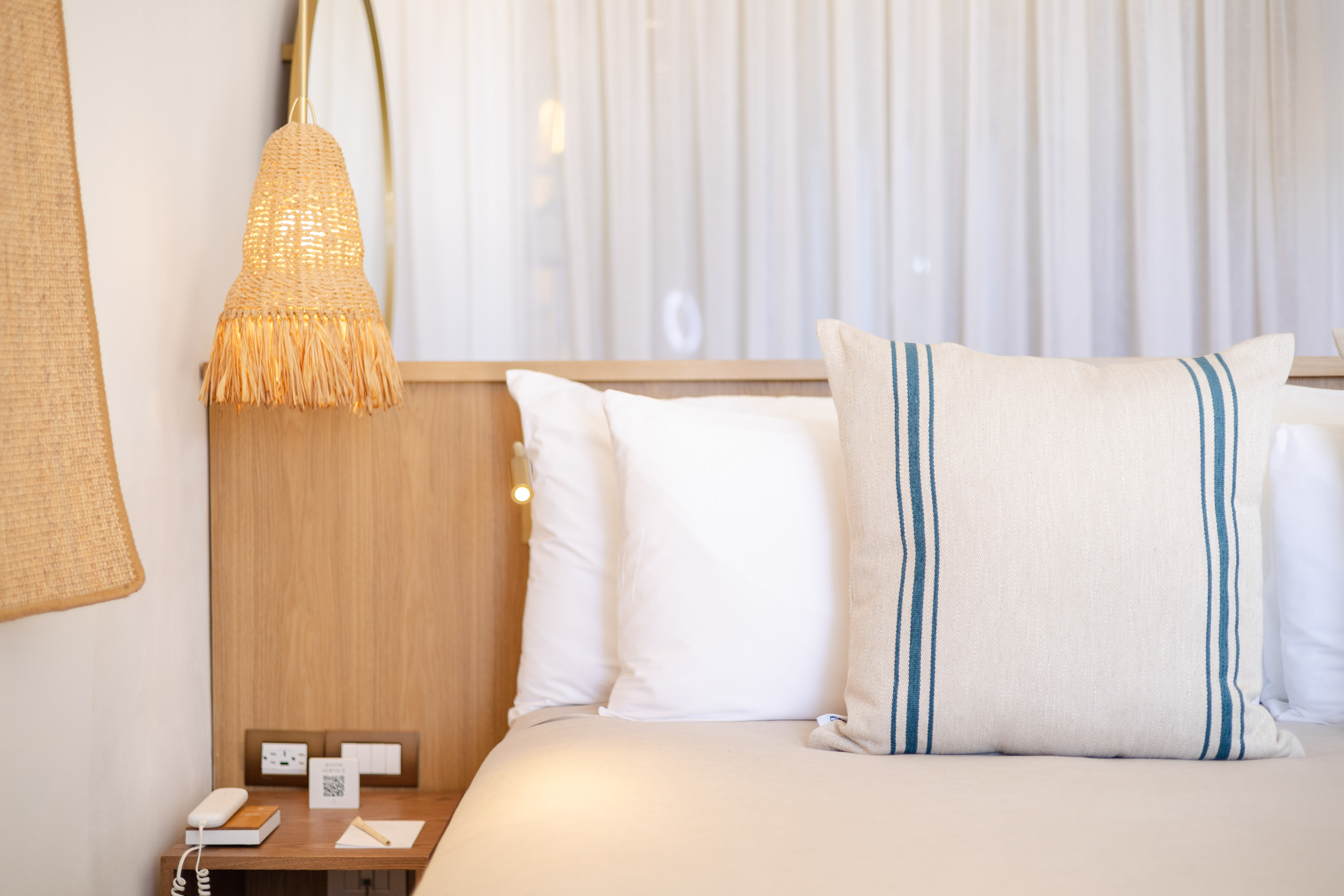 a bed with pillows and a lamp