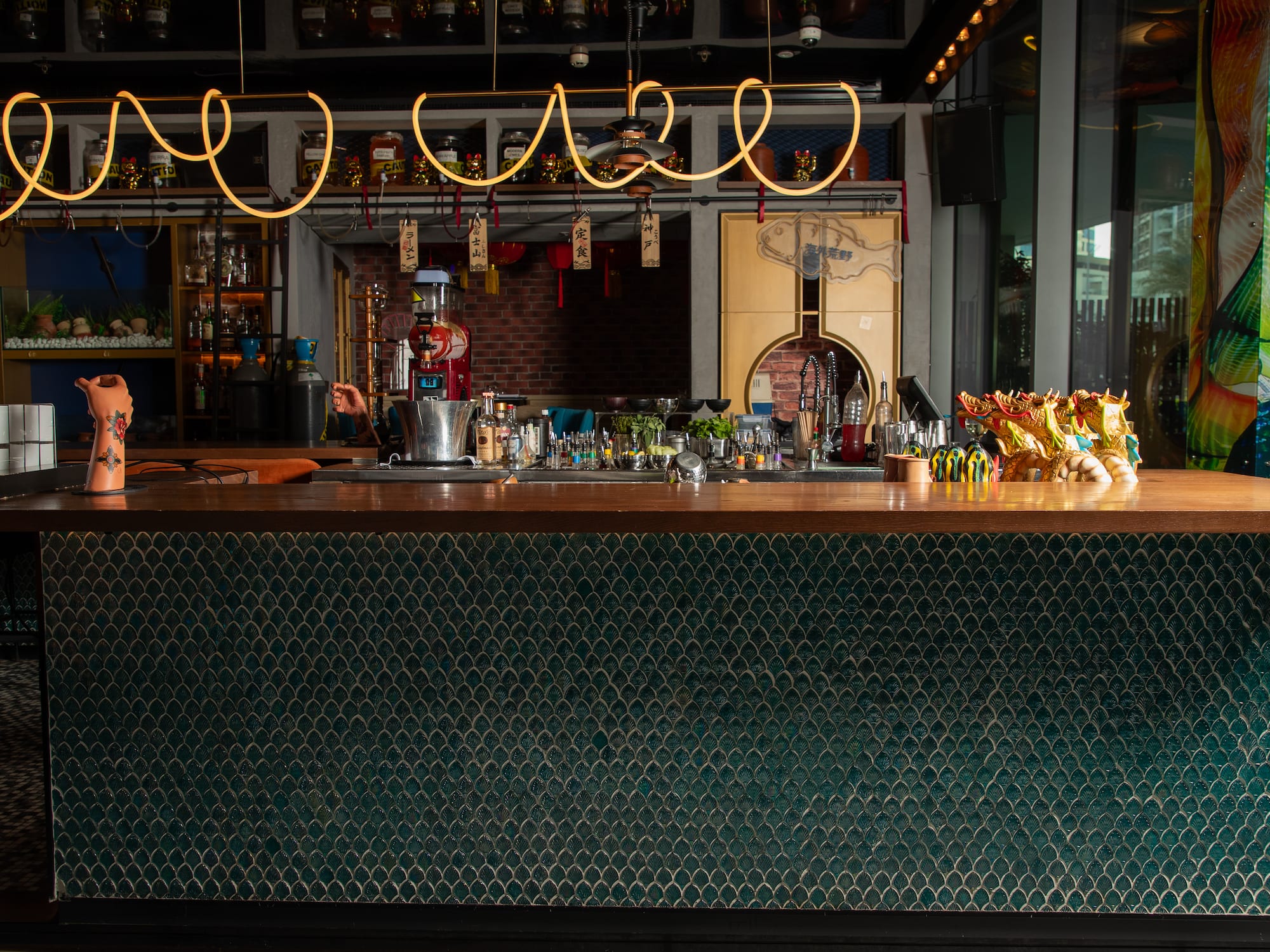 a bar with a green counter and a green wall