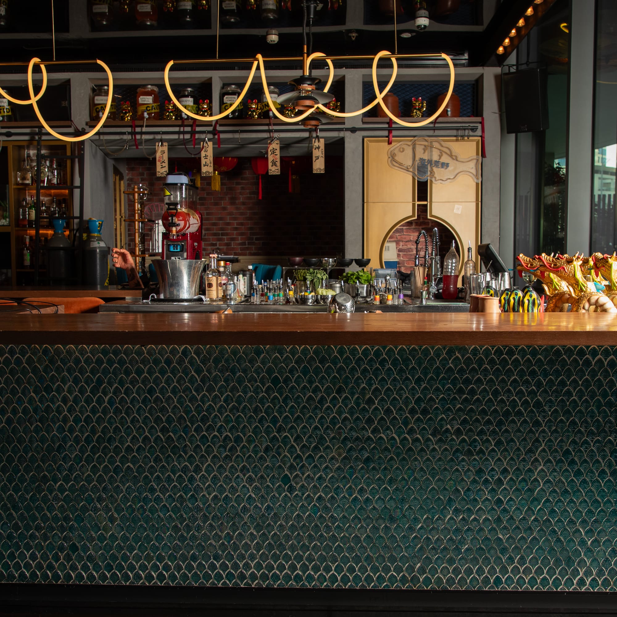 a bar with a green counter and a green wall