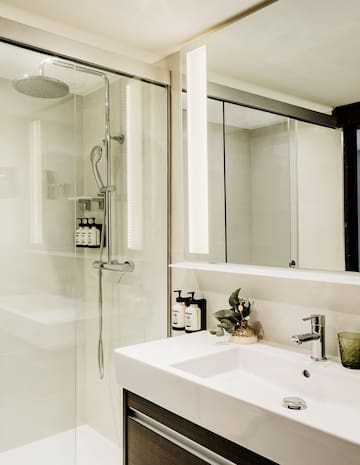 a bathroom with a shower and sink