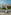 Couple biking on a bridge in Berlin with the Reichstag building dome and flag.