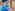 Indoor hotel swimming pool with blue tiles, water features, and spa loungers.