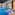 Indoor luxury spa pool with blue mosaic tiles and elegant waterfall features.