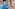 Indoor hotel swimming pool with blue tiles, water features, and spa loungers.