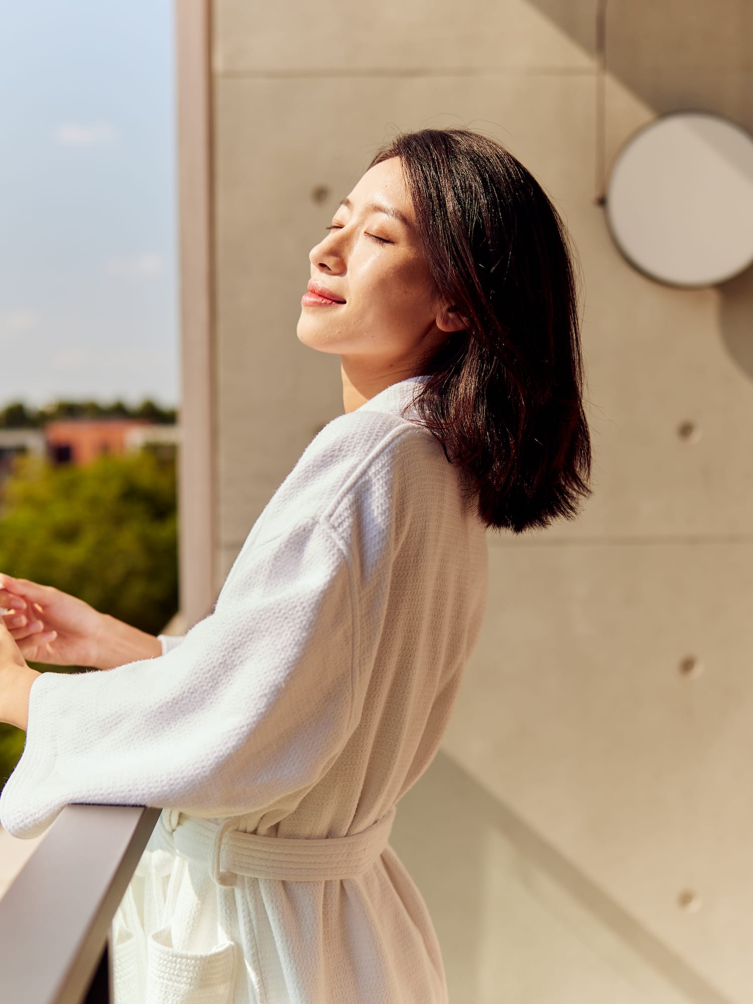 a woman in a bathrobe holding a cup