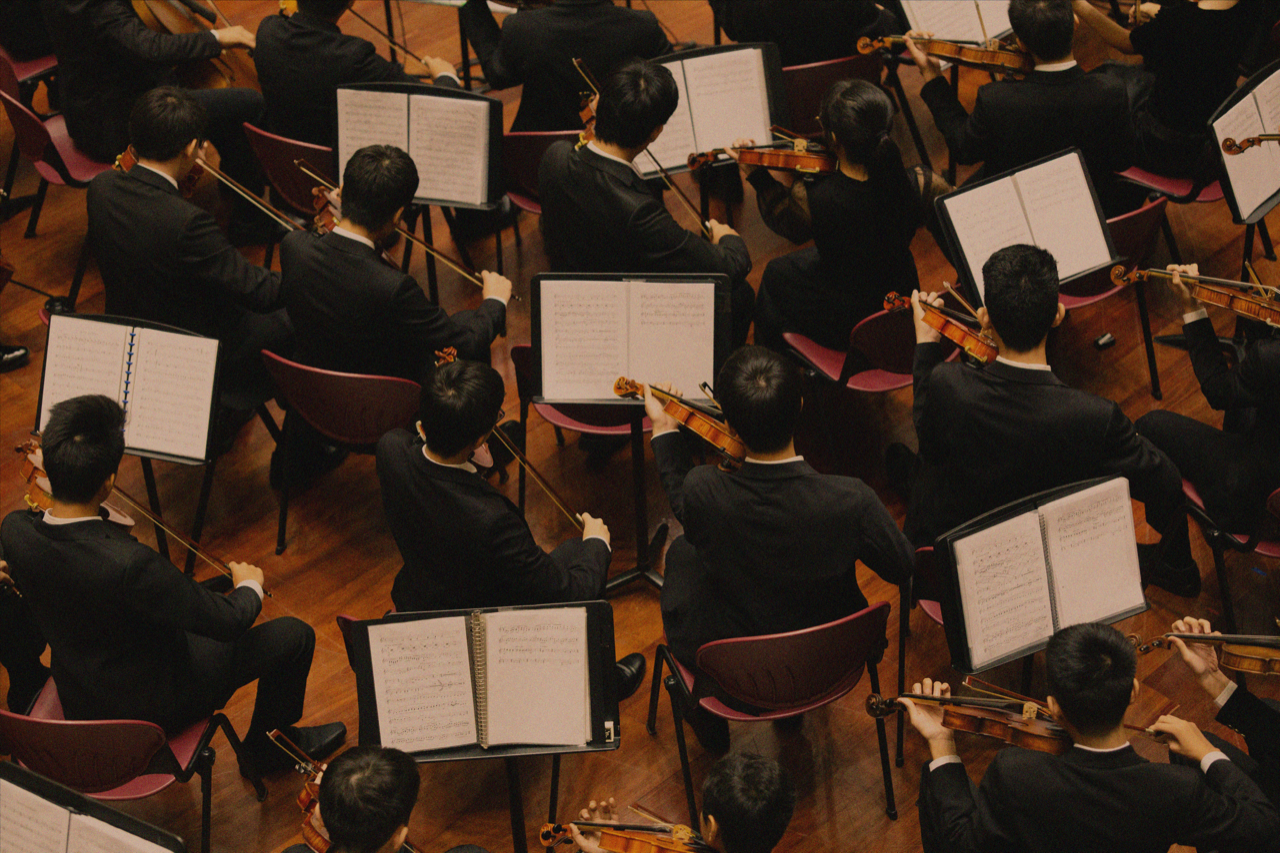 a group of people playing violin