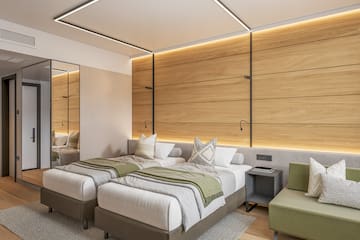 a room with a wood wall and a glass door