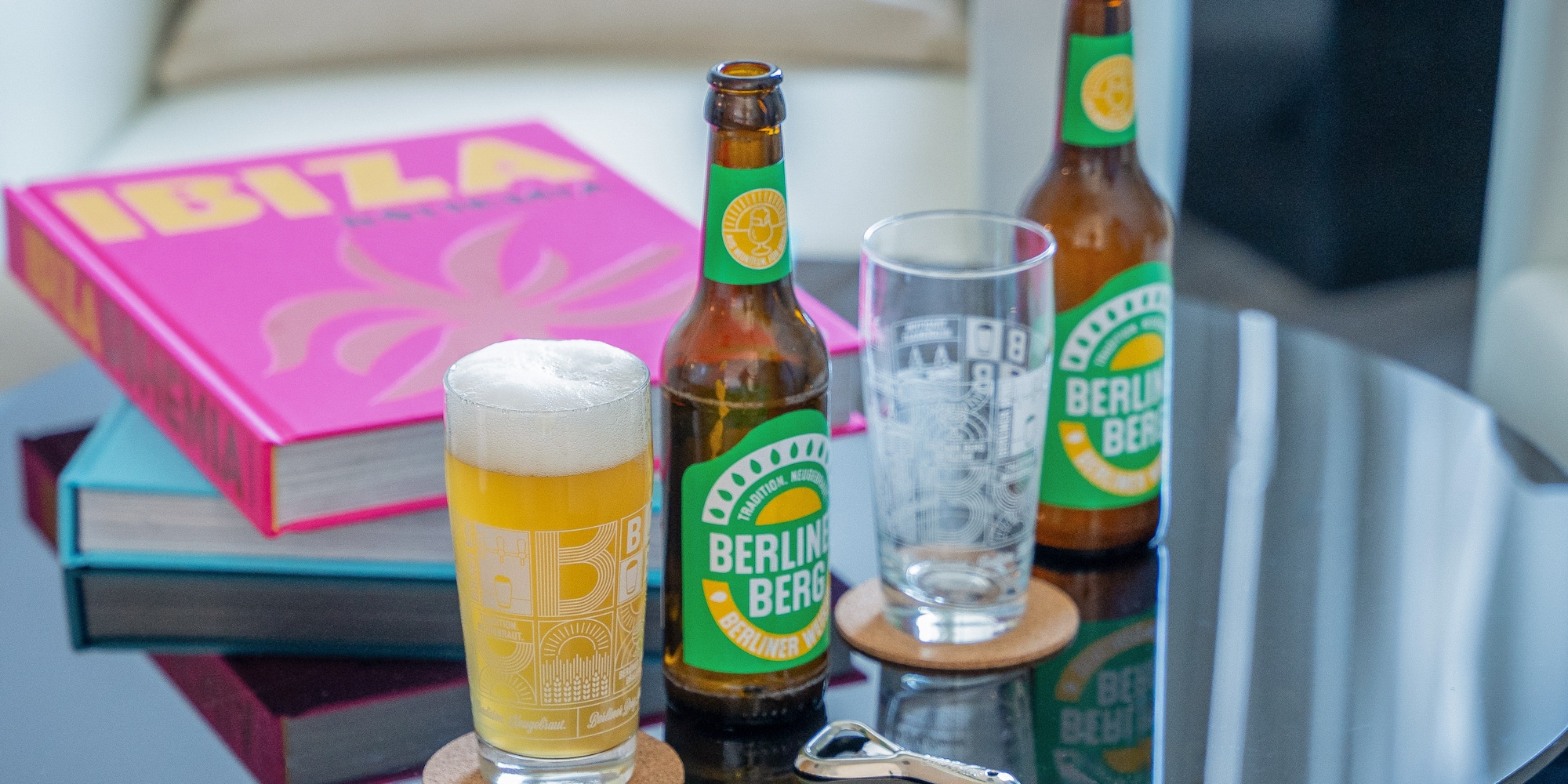 a group of beer bottles and glasses on a table