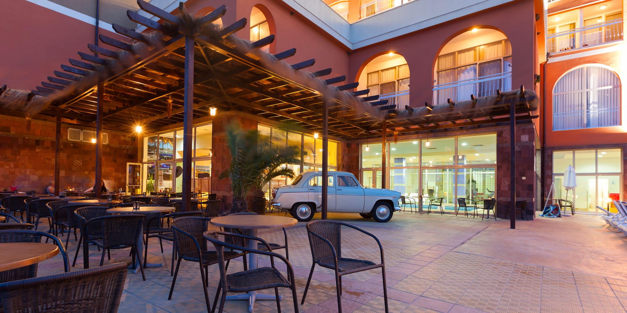 a patio with a table and chairs outside a building