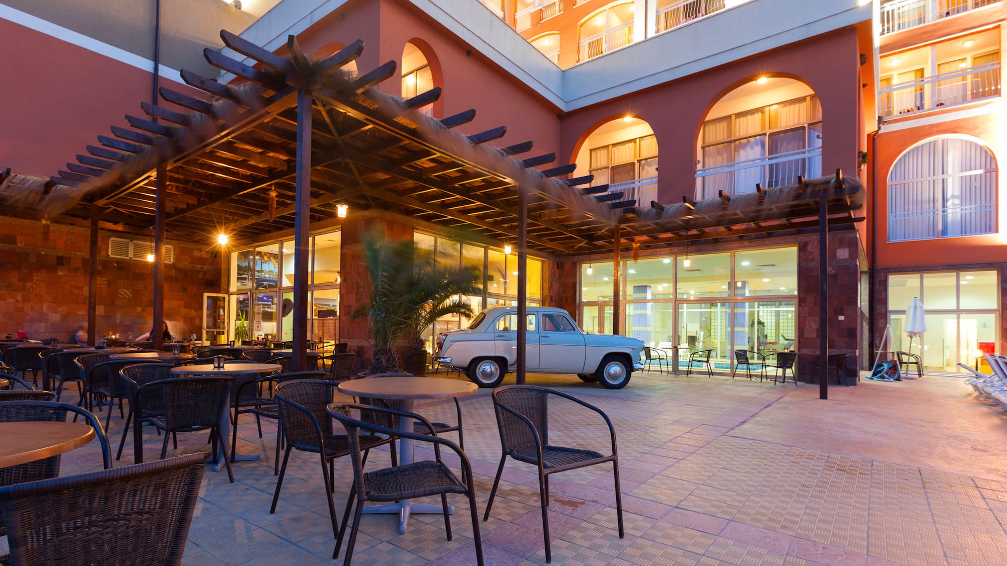 a patio with a table and chairs outside a building