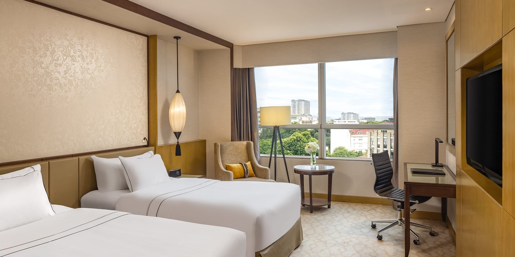 a hotel room with two beds and a desk