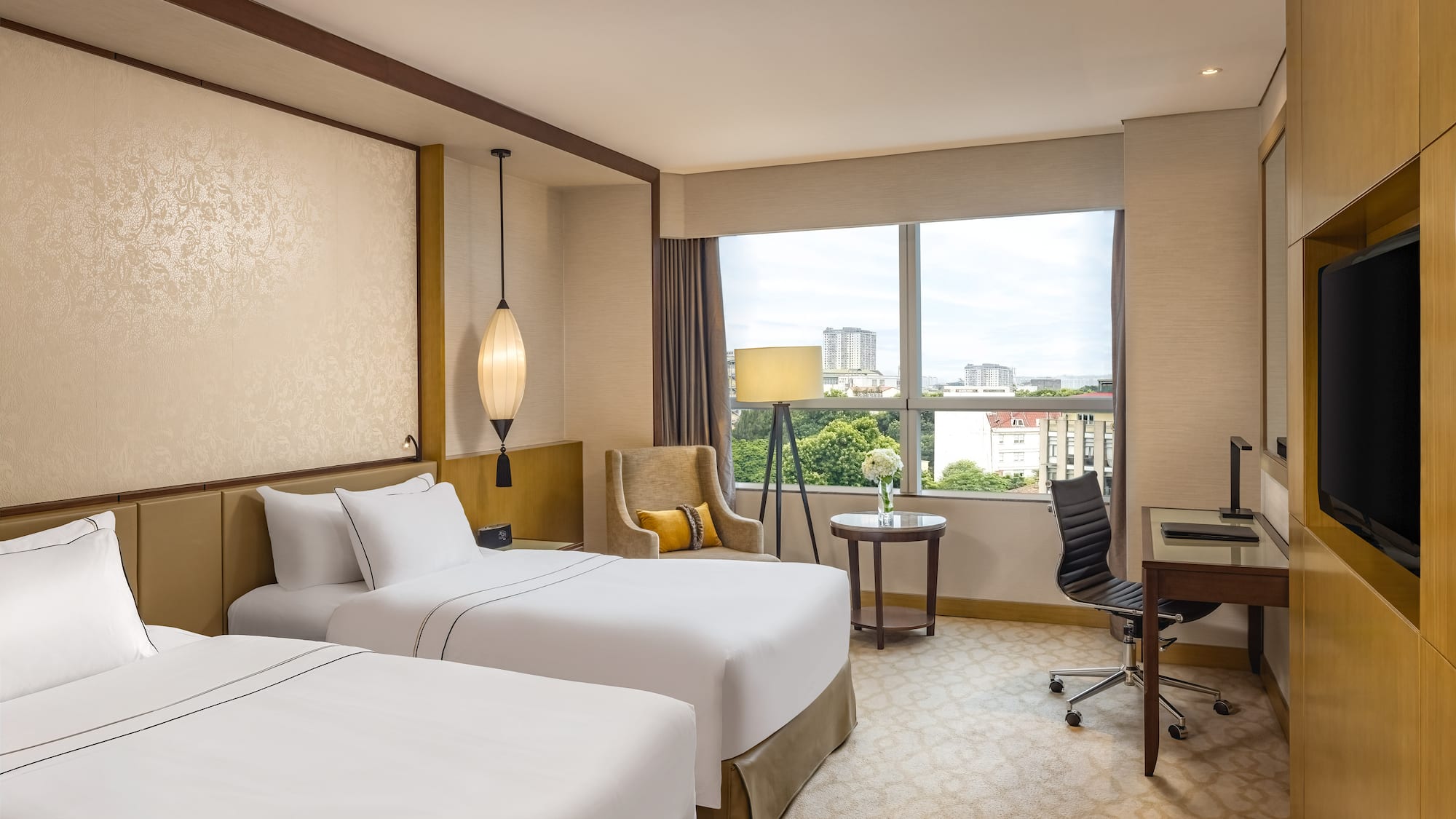 a hotel room with two beds and a desk