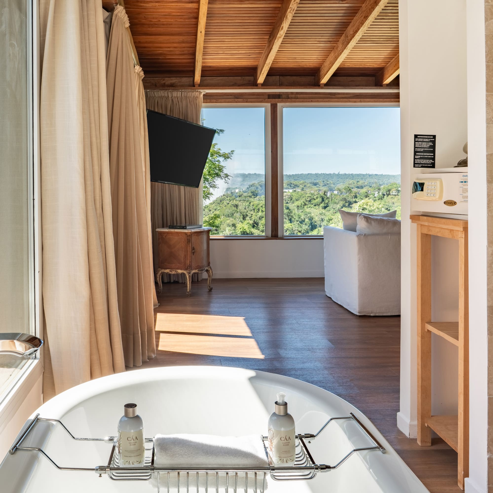 a bathroom with a tub and a television