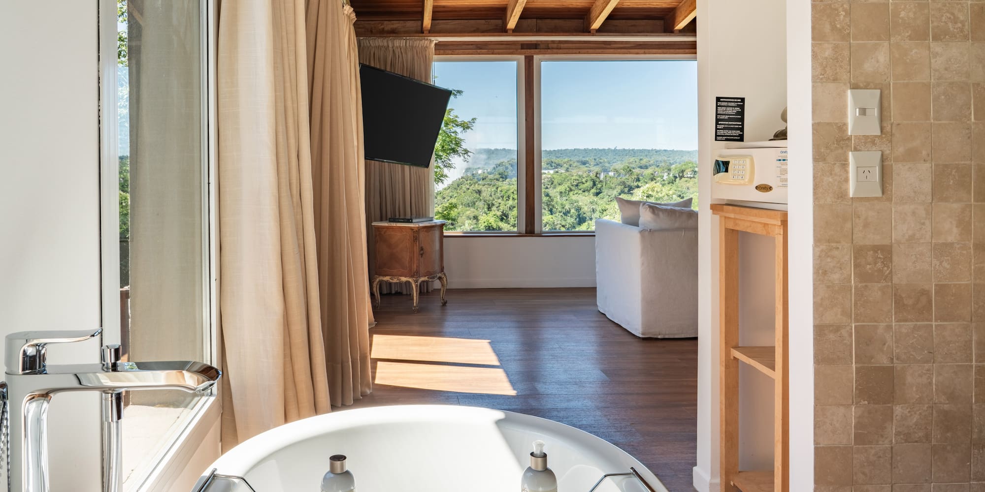 a bathroom with a tub and a television