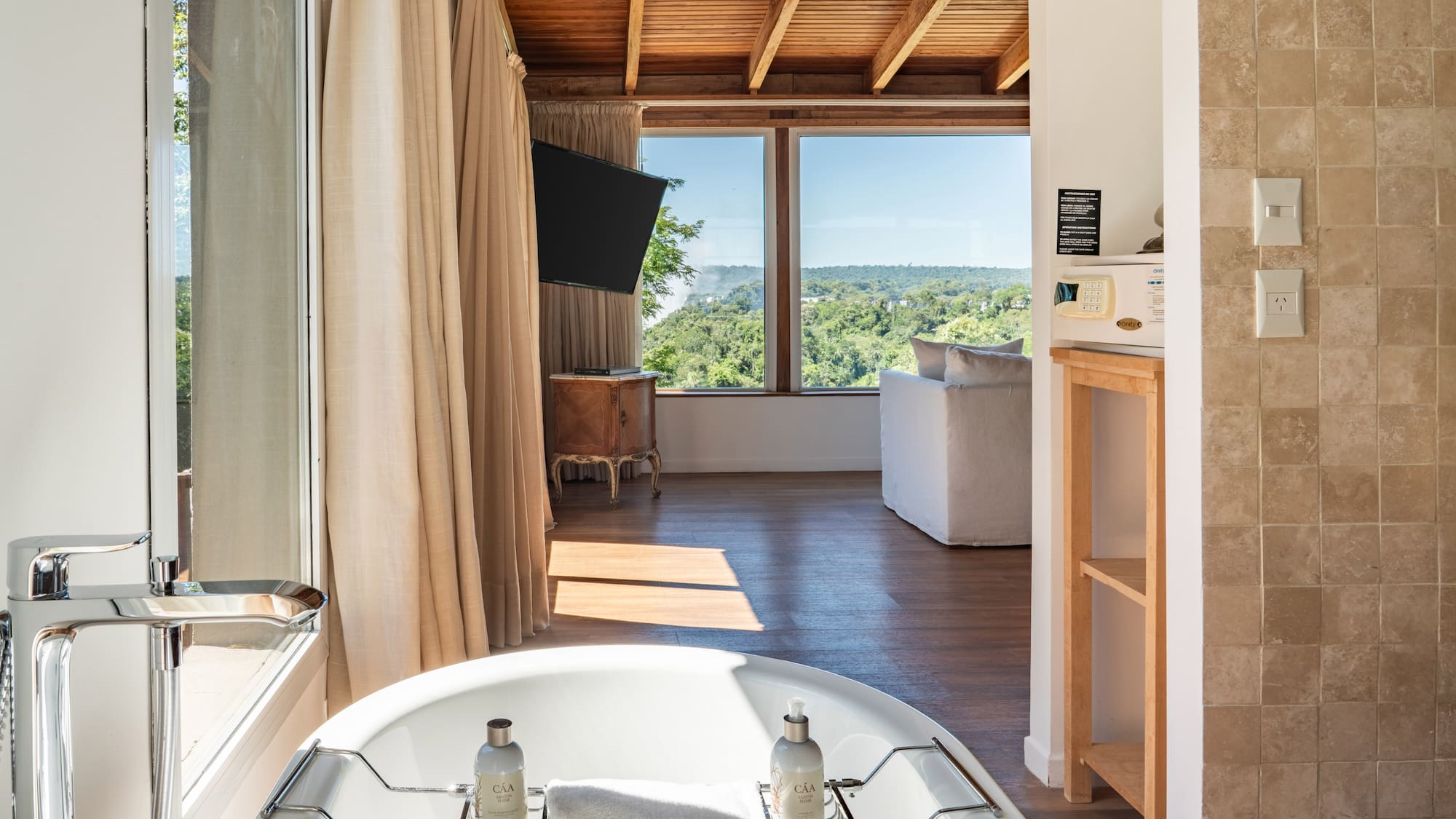a bathroom with a tub and a television