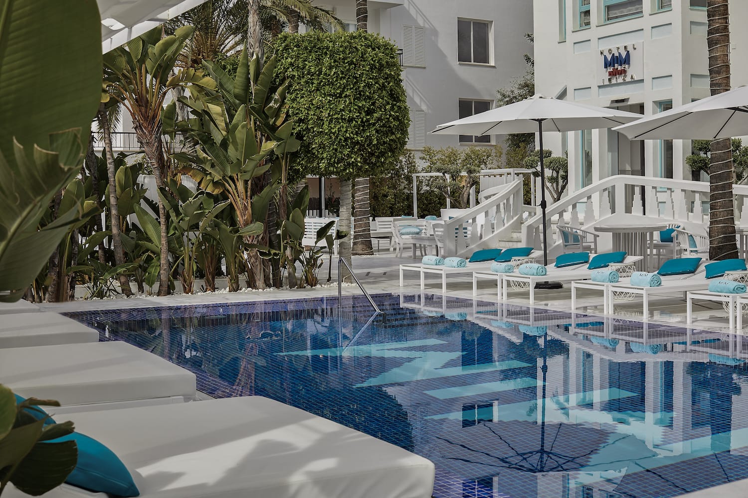 a pool with lounge chairs and umbrellas