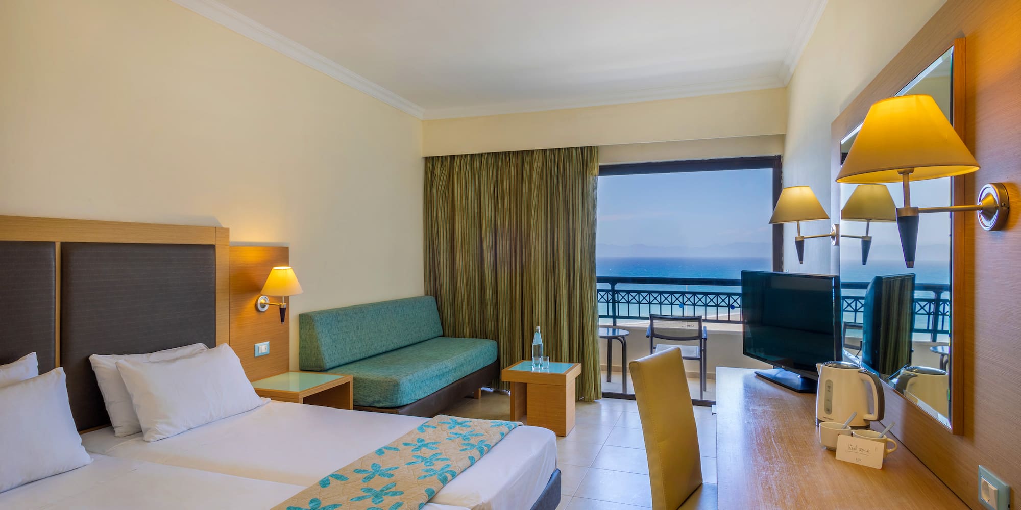 a room with two beds and a television