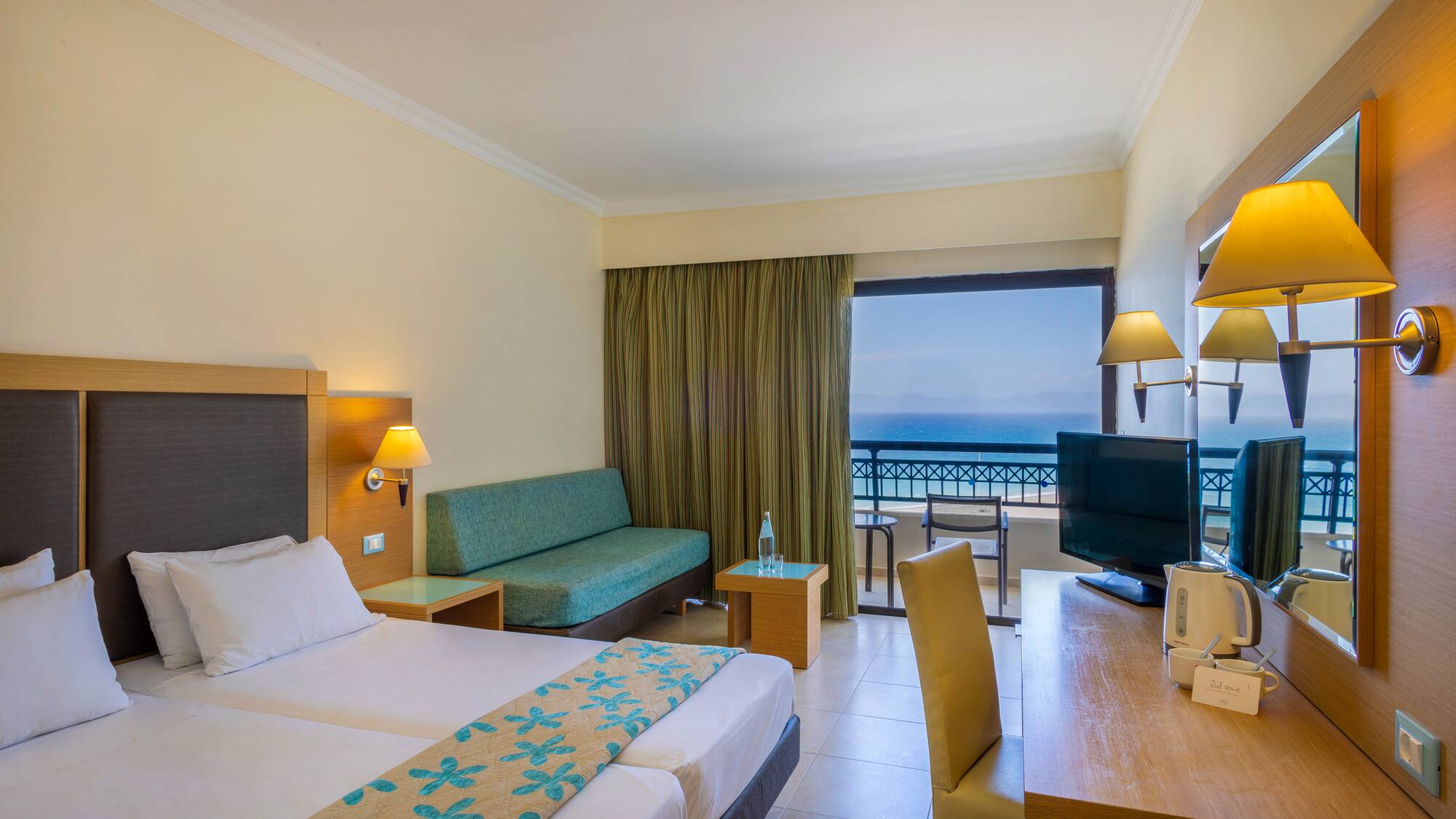 a room with two beds and a television