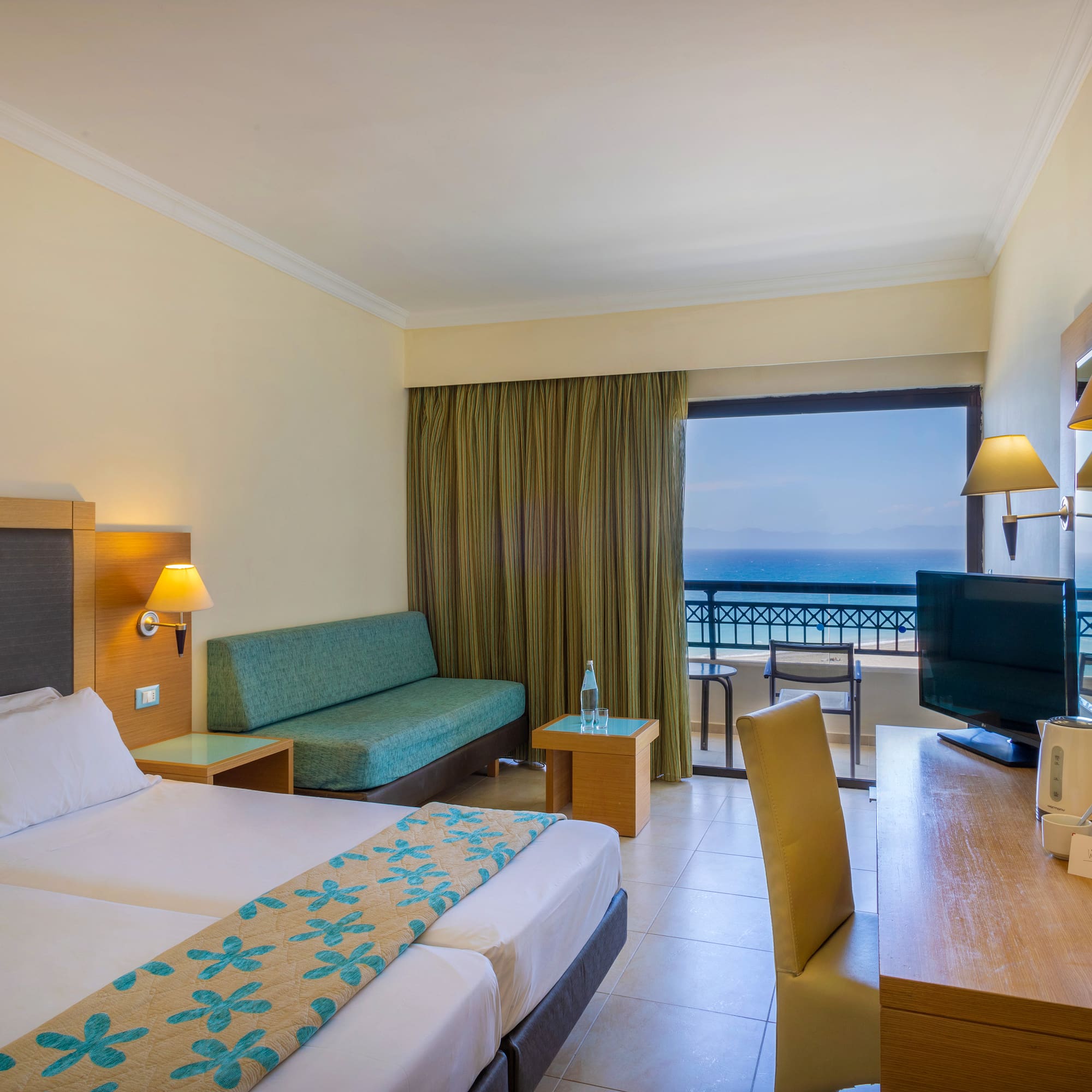 a room with two beds and a television