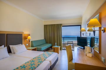 a room with two beds and a television