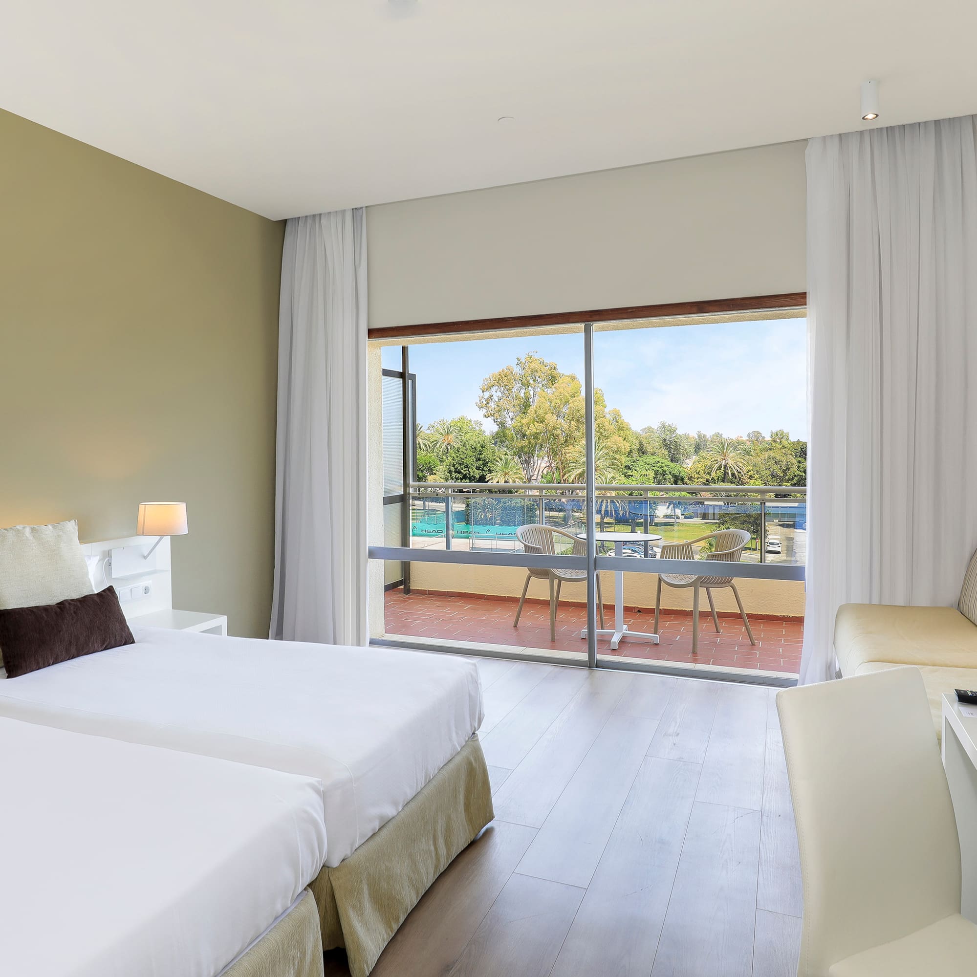 a room with two beds and a glass door